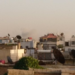 Smoke from cluster bombs exploding over Hajar Aswad, southern suburbs of Damascus